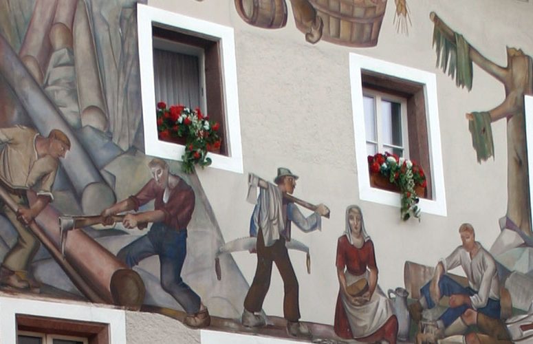 Lüftlmalerei an der Fassade: Holzfäller und Flößer über den Fenstern mit Blumenkästen